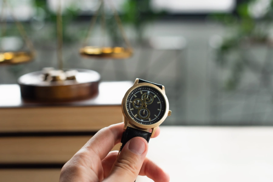 partial-view-of-lawyer-holding-wristwatch-near-blu-2024-11-13-13-41-19-utc