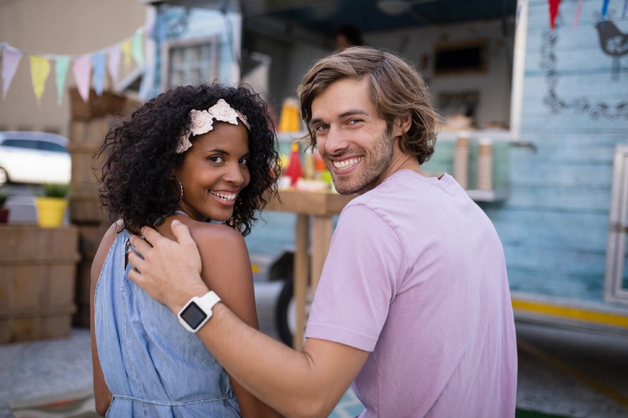 portrait-of-happy-couple-sitting-near-food-truck-2025-04-03-03-45-28-utc