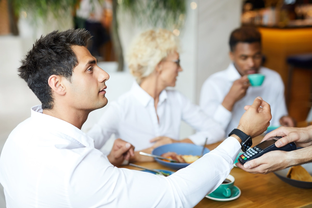 young-manager-paying-for-lunch-with-smartwatch-2025-03-31-08-35-26-utc-tradewatchseo